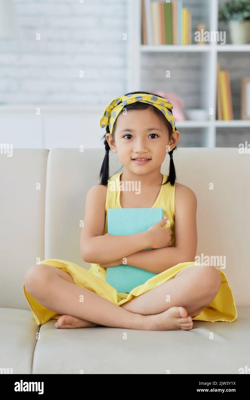 Pretty young Vietnamese girl sitting on sofa Stock Photo Alamy