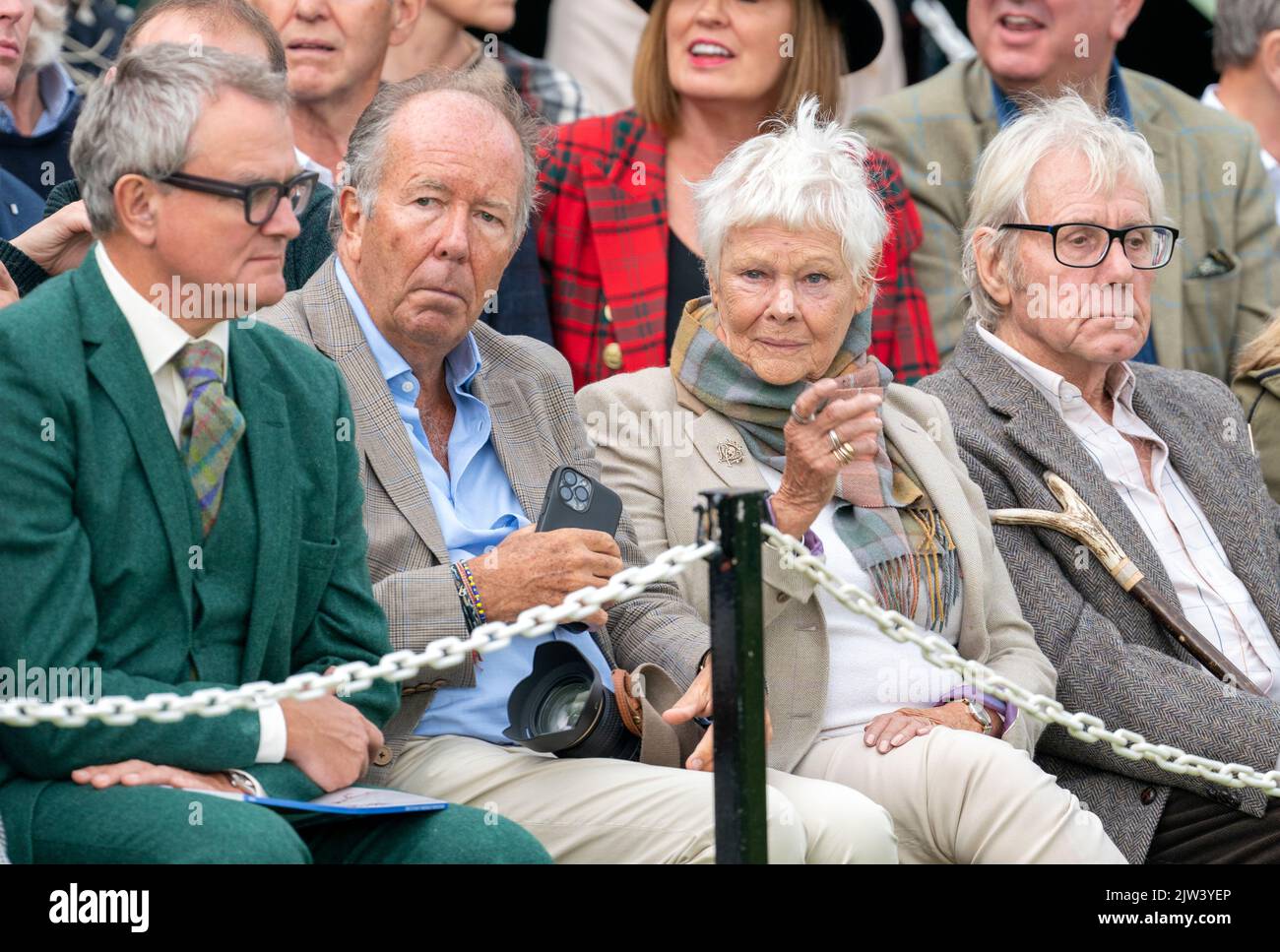 Dame Judi Dench and David Mills (right) watching the Braemar Royal ...