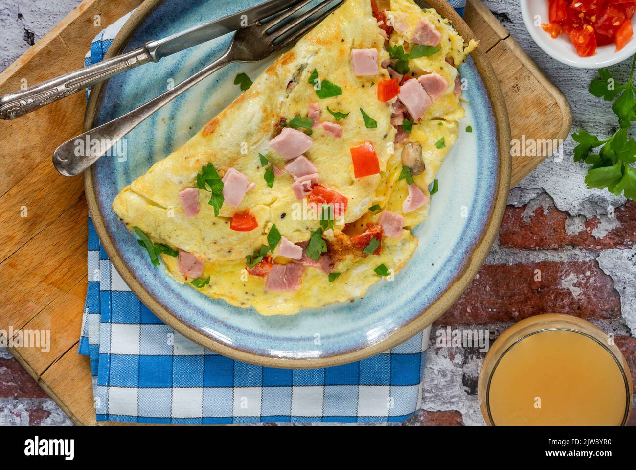 Egg omelette with ham, mushrooms and tomatoes Stock Photo - Alamy