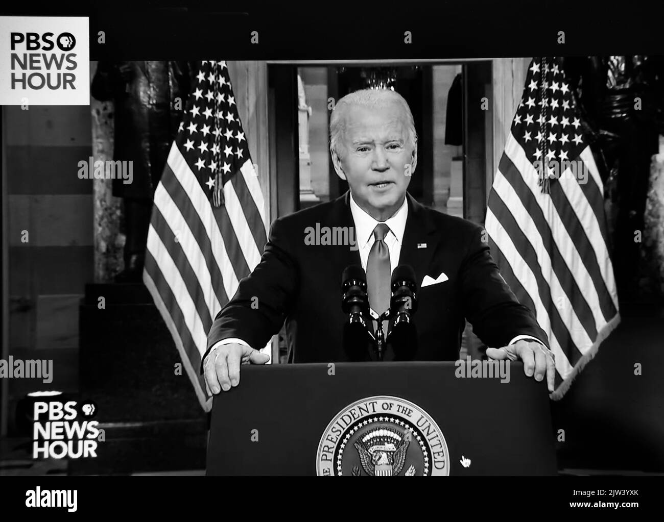A PBS TV NewsHour screen shot of U.S. President Joe Biden speaking on the one-year anniversary of the January 6 attack on the U.S. Capitol. Stock Photo