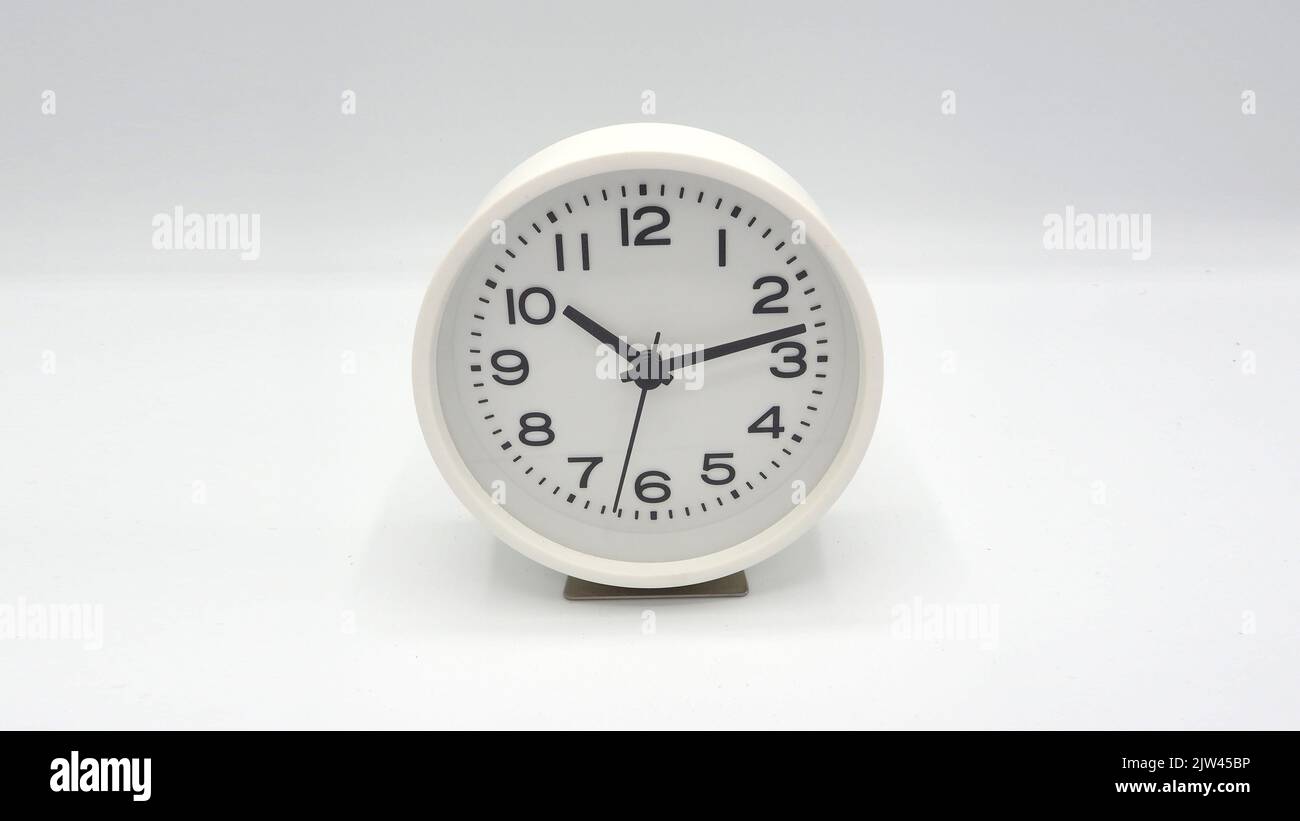 Modern and clean white color clock with minute hand and hour hand on