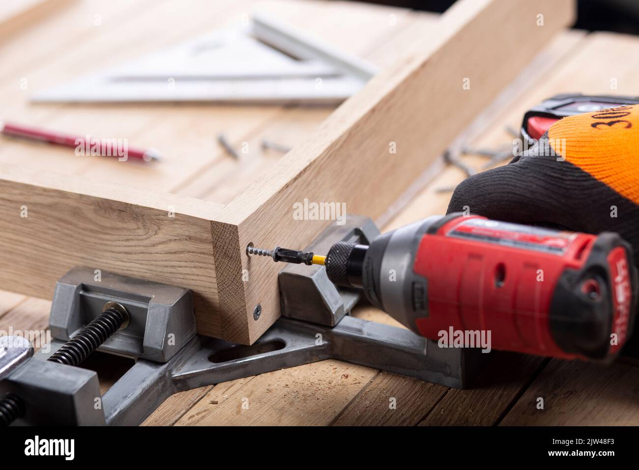 Driving screws into a wooden frame with an impact drill Stock Photo Alamy