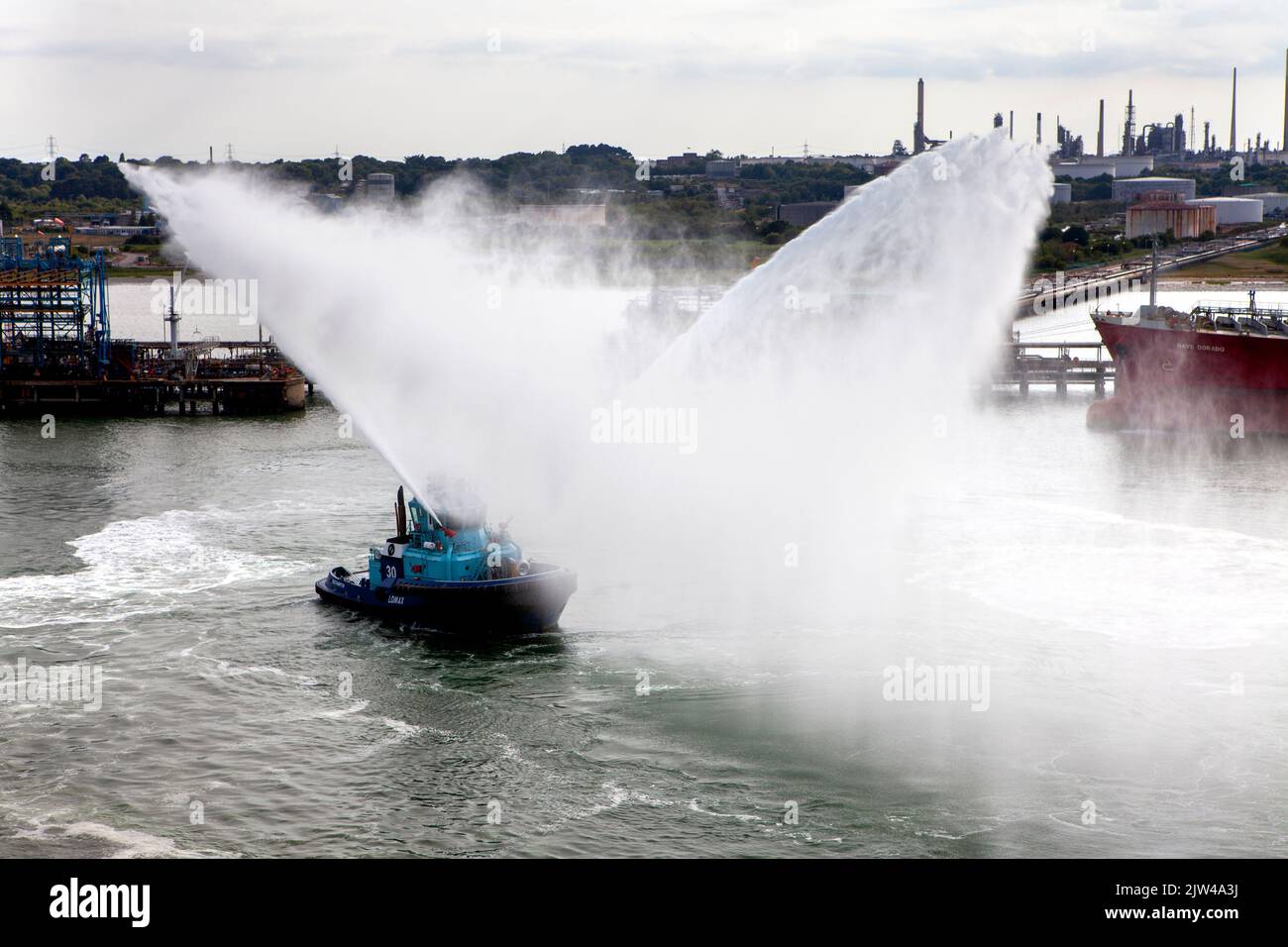 Lomax Fire Fighting Vessel tug water saluting cruise ship Stock Photo