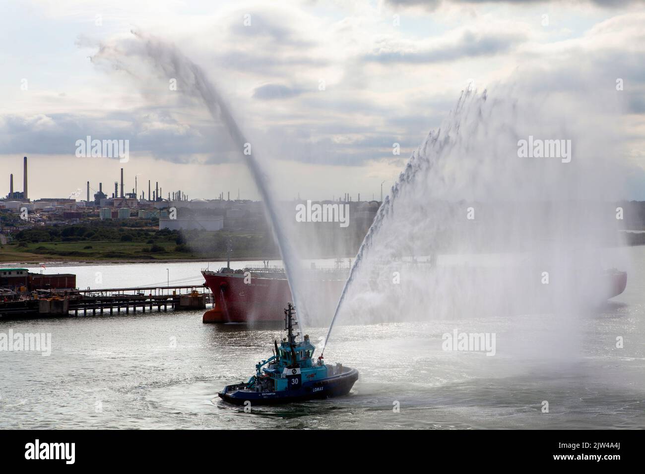 Lomax Fire Fighting Vessel tug water saluting cruise ship Stock Photo