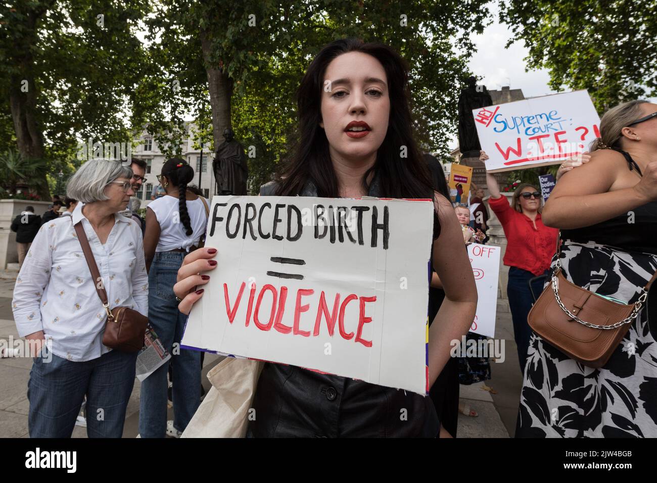 London, UK. 3rd September, 2022. A woman holds a placard as pro-choice supporters stage a demonstration in Parliament Square to campaign for women's reproductive rights around the world as a counter-protest to the anti-abortion 'March for Life'  taking place alongside. The demonstrators also expressed solidarity with women in US where the Supreme Court overturned the 1973 Roe v Wade law, which affirmed the federal constitutional right to seek an abortion. Credit: Wiktor Szymanowicz/Alamy Live News Stock Photo