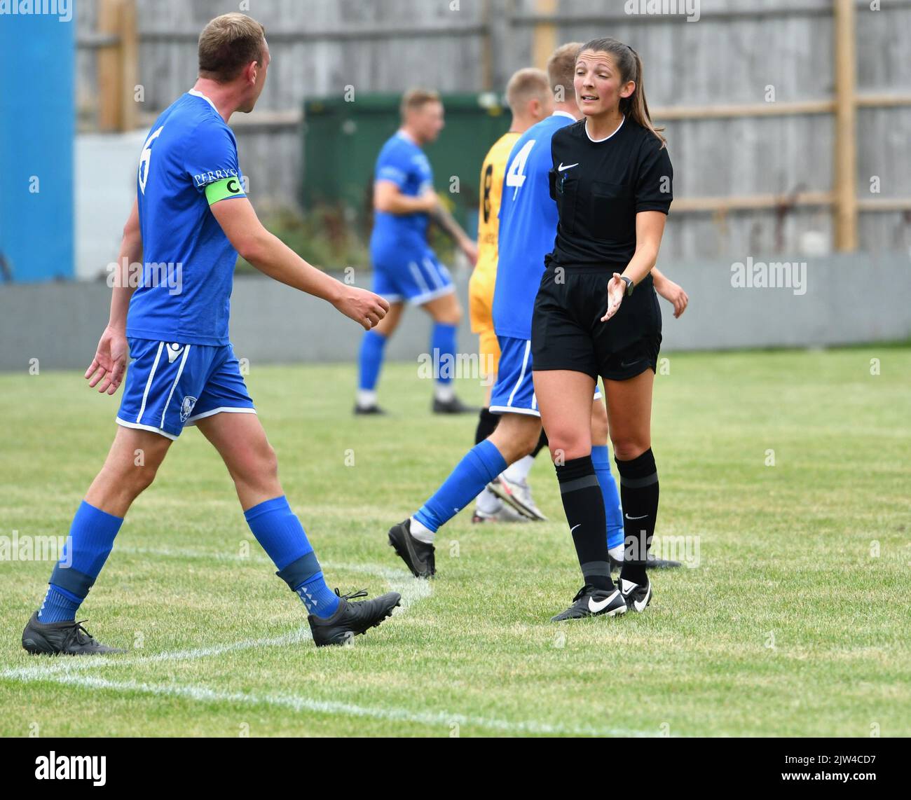 A female referee officiating at the semi-professional football match ...