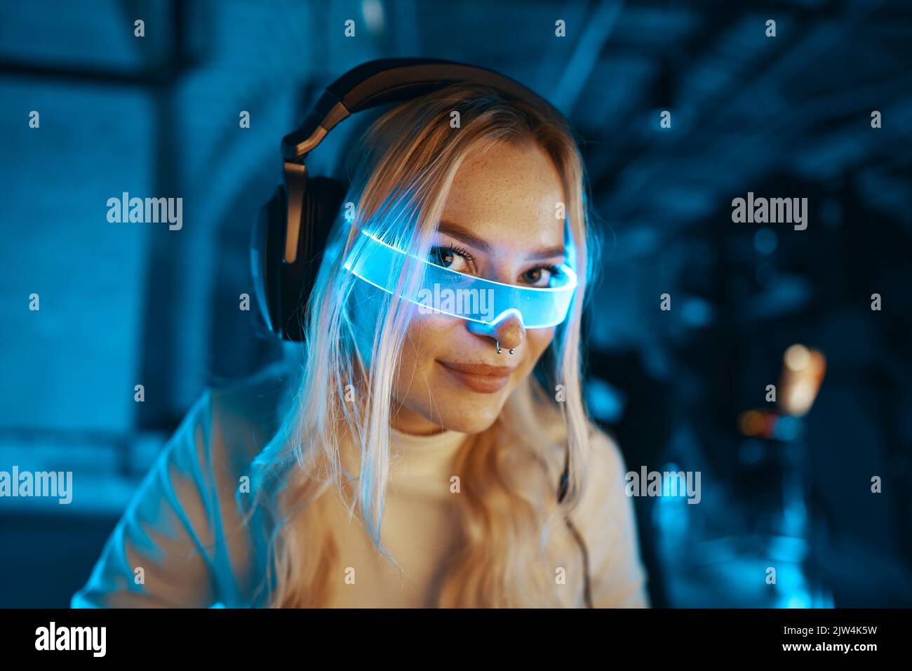 Blonde Computer Program The blonde is playing a computer game. Blogger in neon futuristic ...
