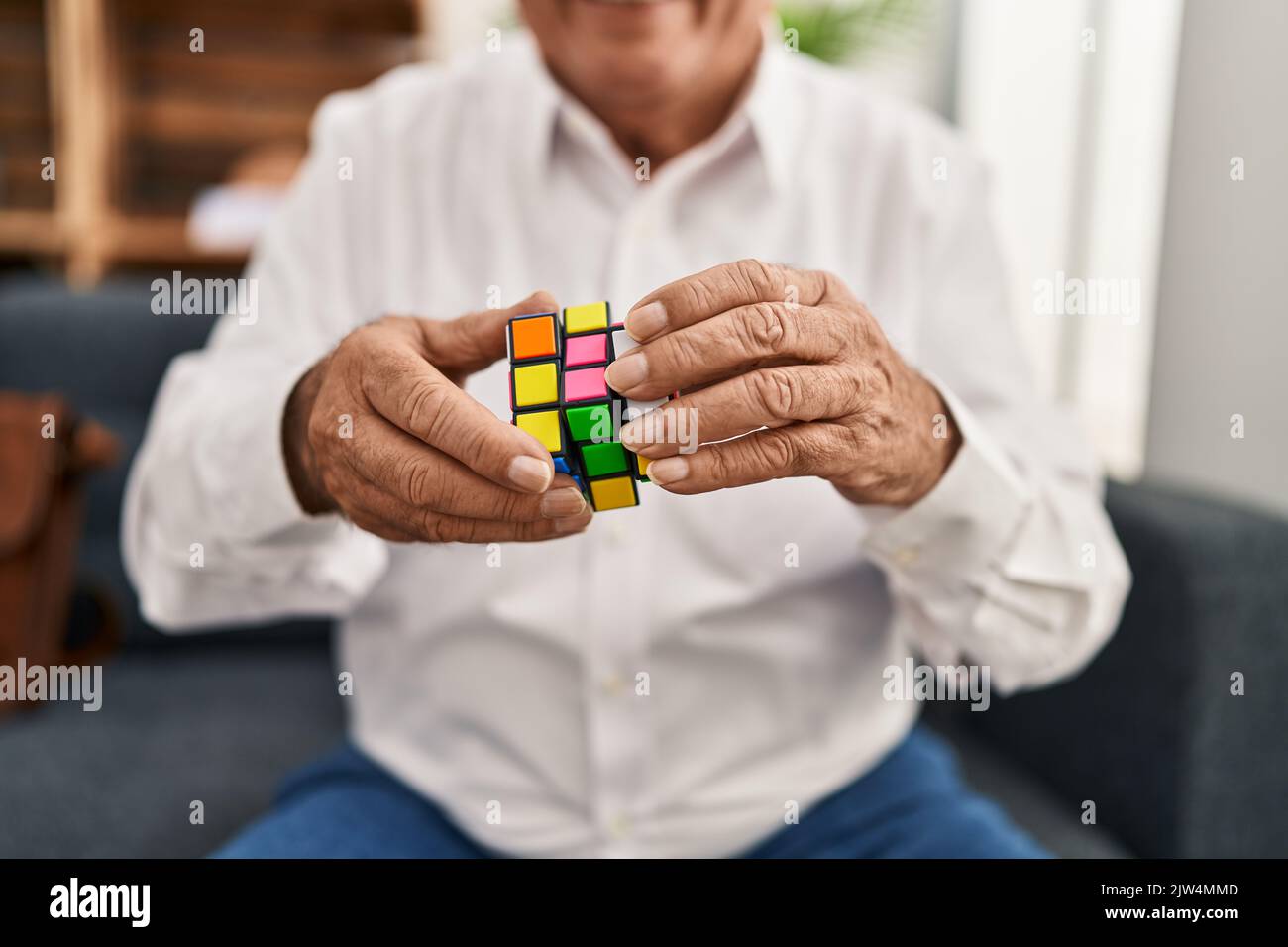 Senior man psychologist playing game at psychology center Stock Photo