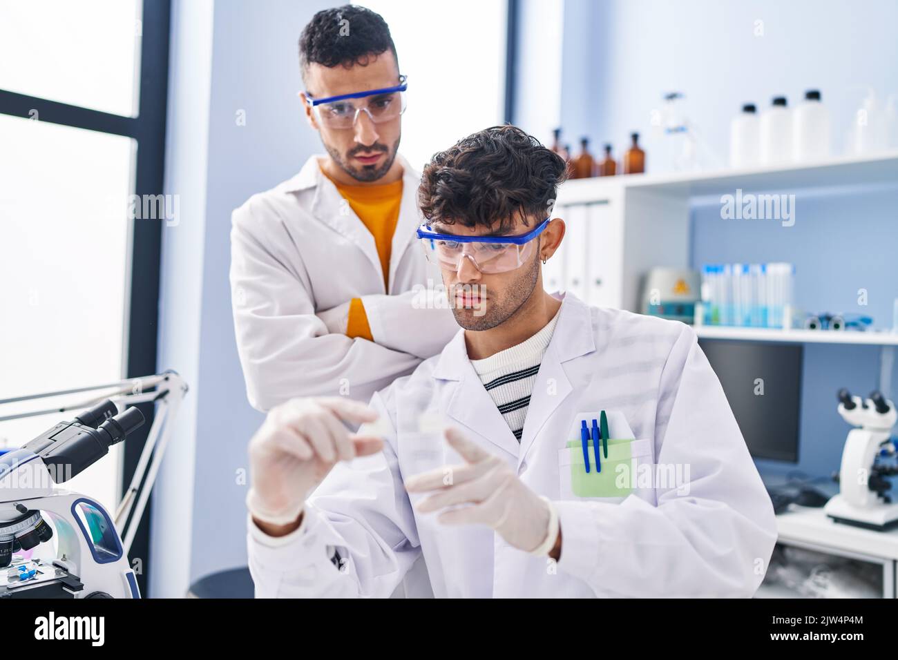 Two man scientists measuring hi-res stock photography and images - Alamy