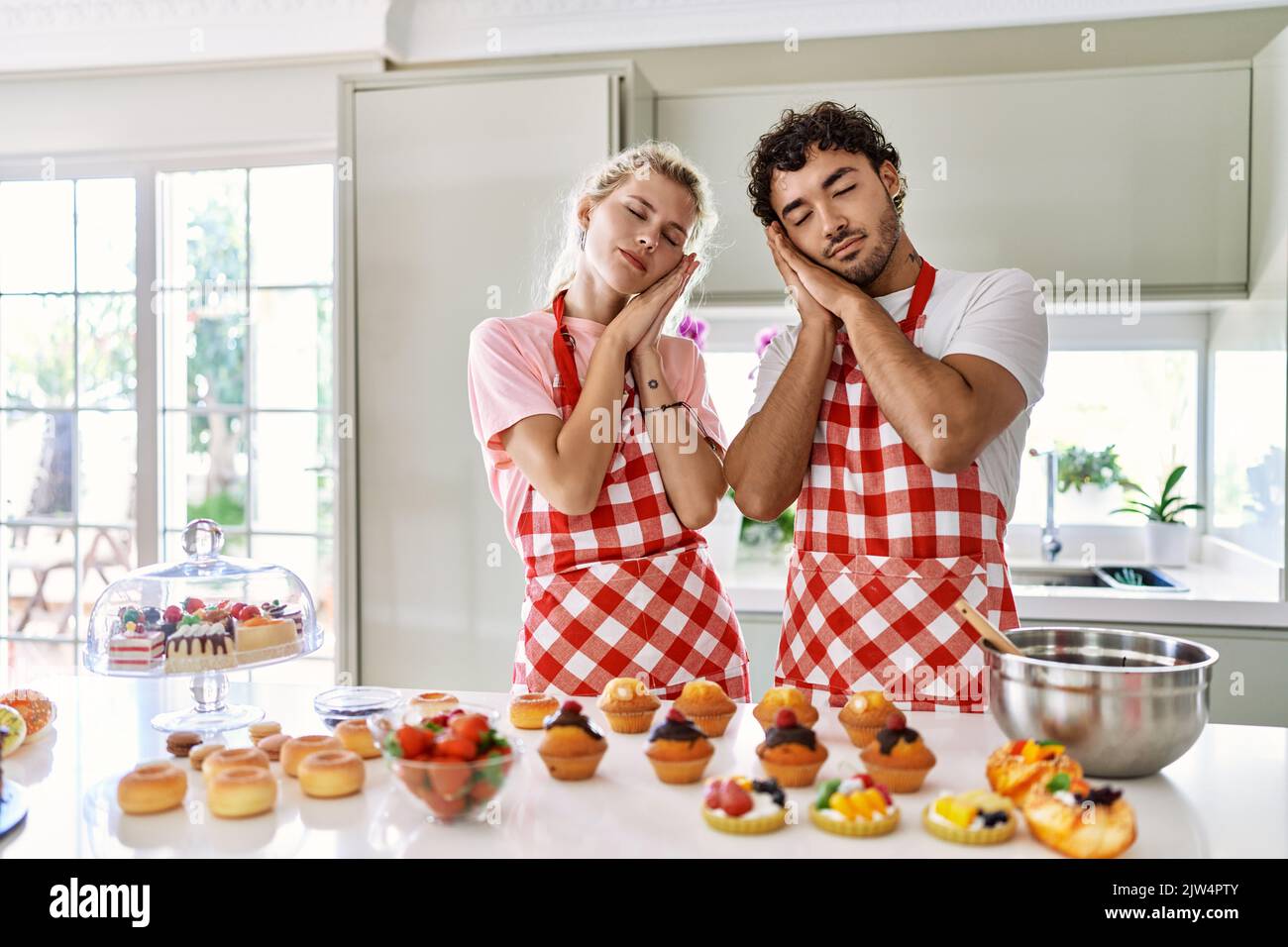 Couple of wife and husband cooking pastries at the kitchen sleeping ...