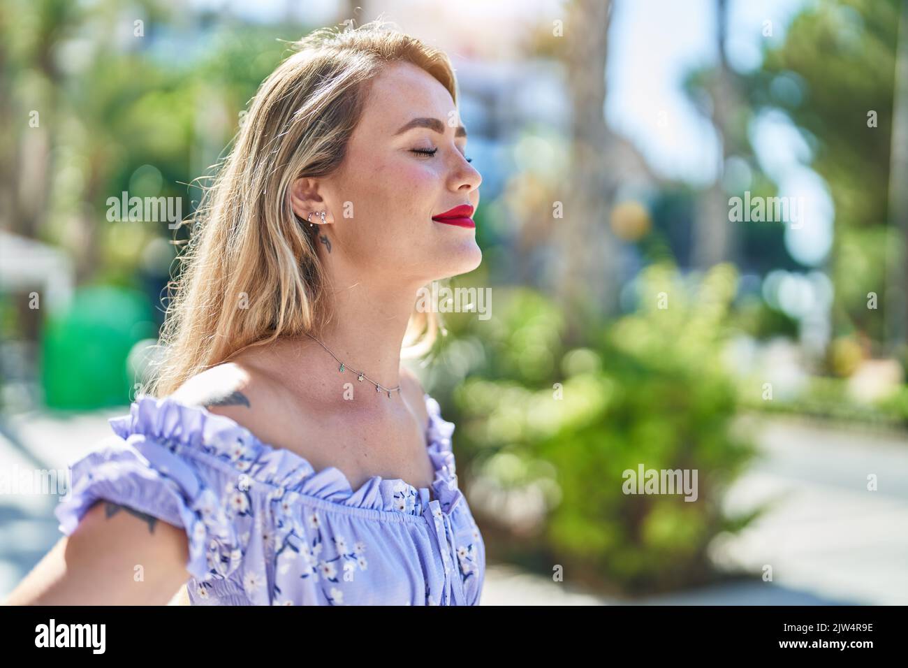 Young beautiful hispanic woman breathing with closed eyes at park Stock ...