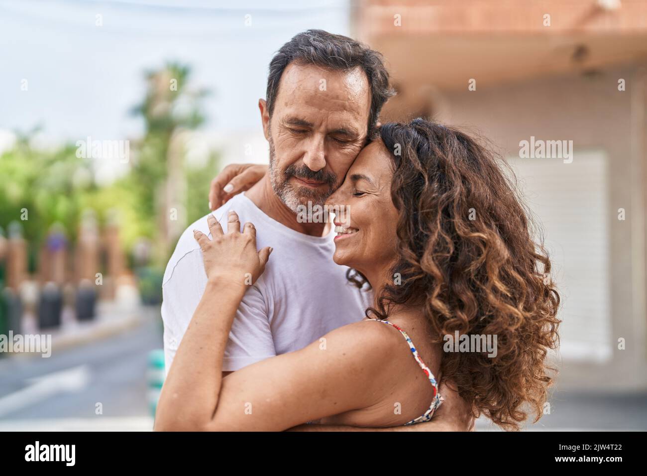 Man and woman couple hugging each other at street Stock Photo - Alamy