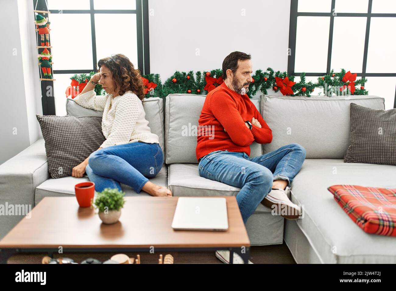 Middle age hispanic couple angry on disagreement sitting on the sofa at ...