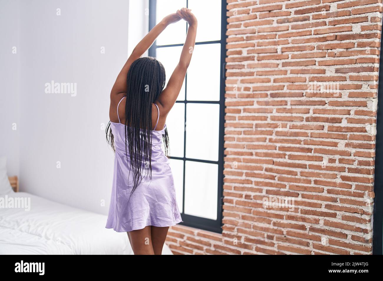 African American Woman Waking Up Stretching Arms At Bedroom Stock Photo ...