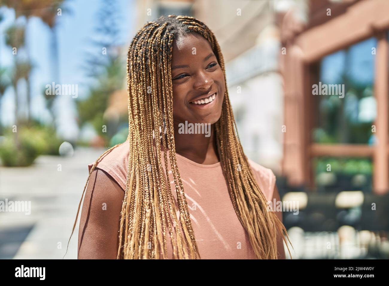 African american woman smiling confident looking to the side at coffee ...