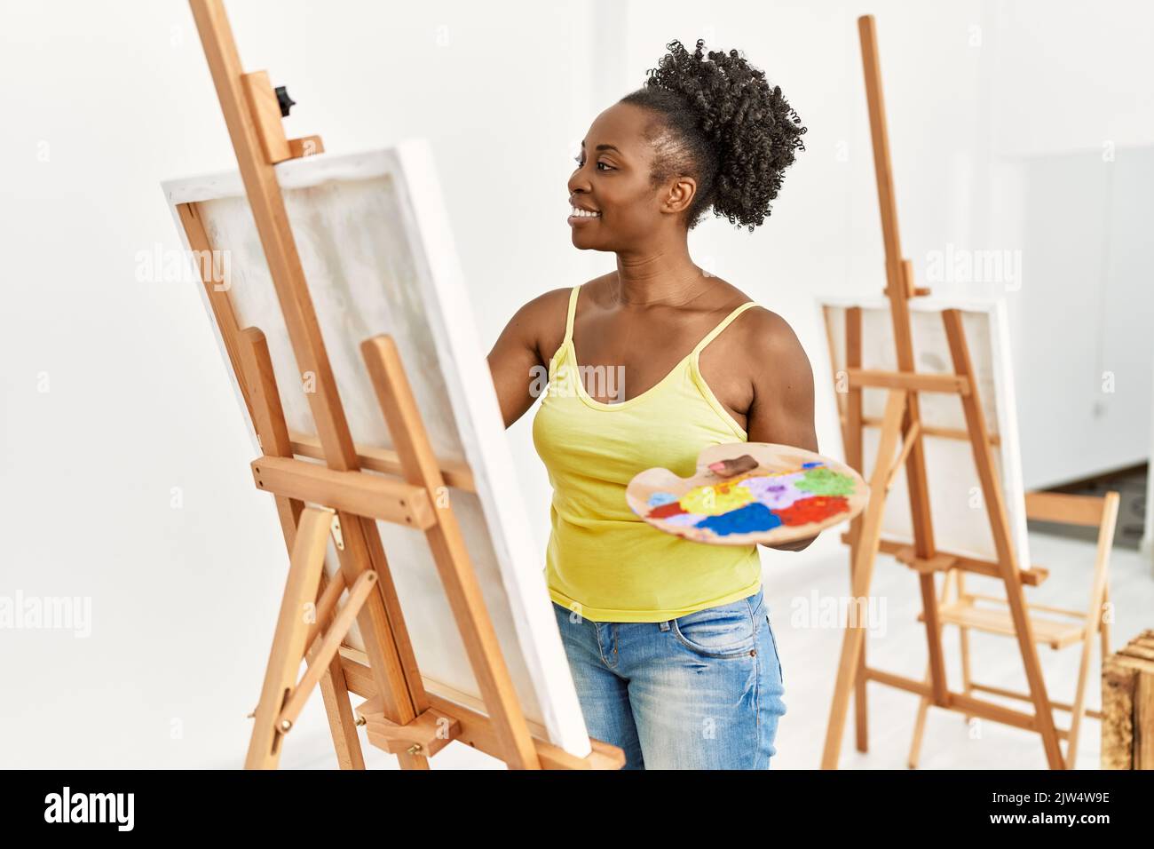 Young african american artist woman smiling happy drawing at art studio ...