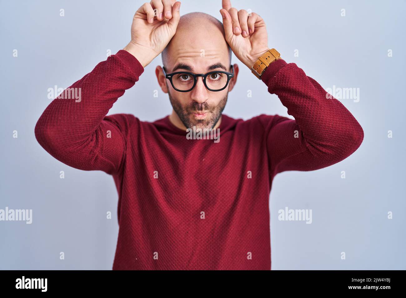 Young Bald Man With Beard Standing Over White Background Wearing Glasses Doing Funny Gesture 5294