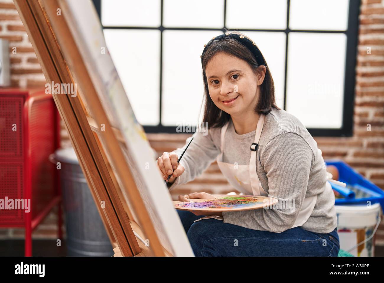 Young Woman With Down Syndrome Artist Smiling Confident Drawing At Art 