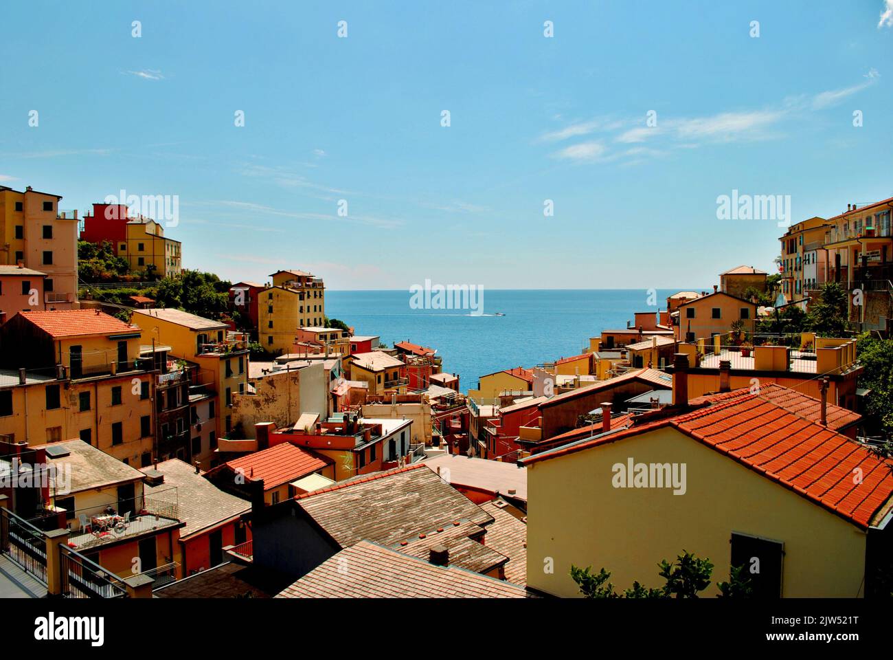 View of rooftops in colorful village by the sea and blue sky Stock Photo