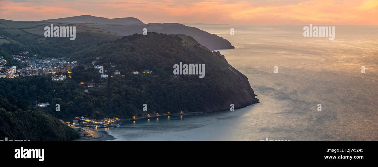 The view after sunset from the top of Countisbury Hill on the northern edge of Exmoor, looking towards Lynton and Lynmouth in North Devon, England. Th Stock Photo