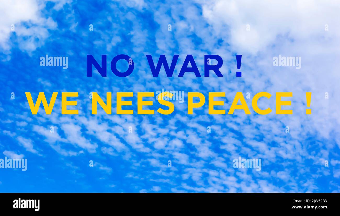 Against the background of the blue sky, the text No war We need peace, painted in the colors of the flag of Ukraine Stock Photo