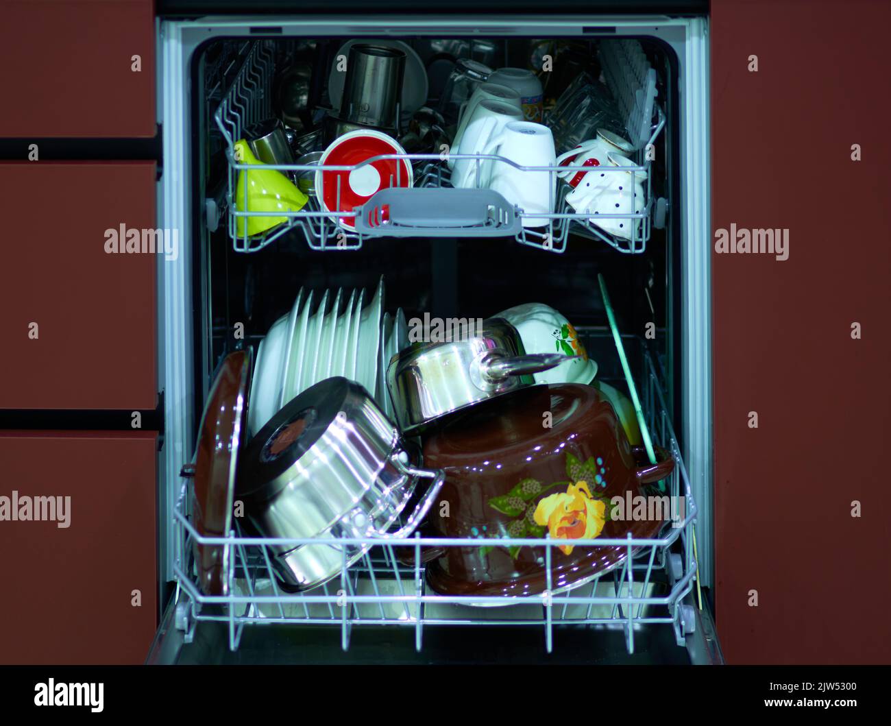 metal or glass dishes in a modern dishwasher in the kitchen Stock Photo