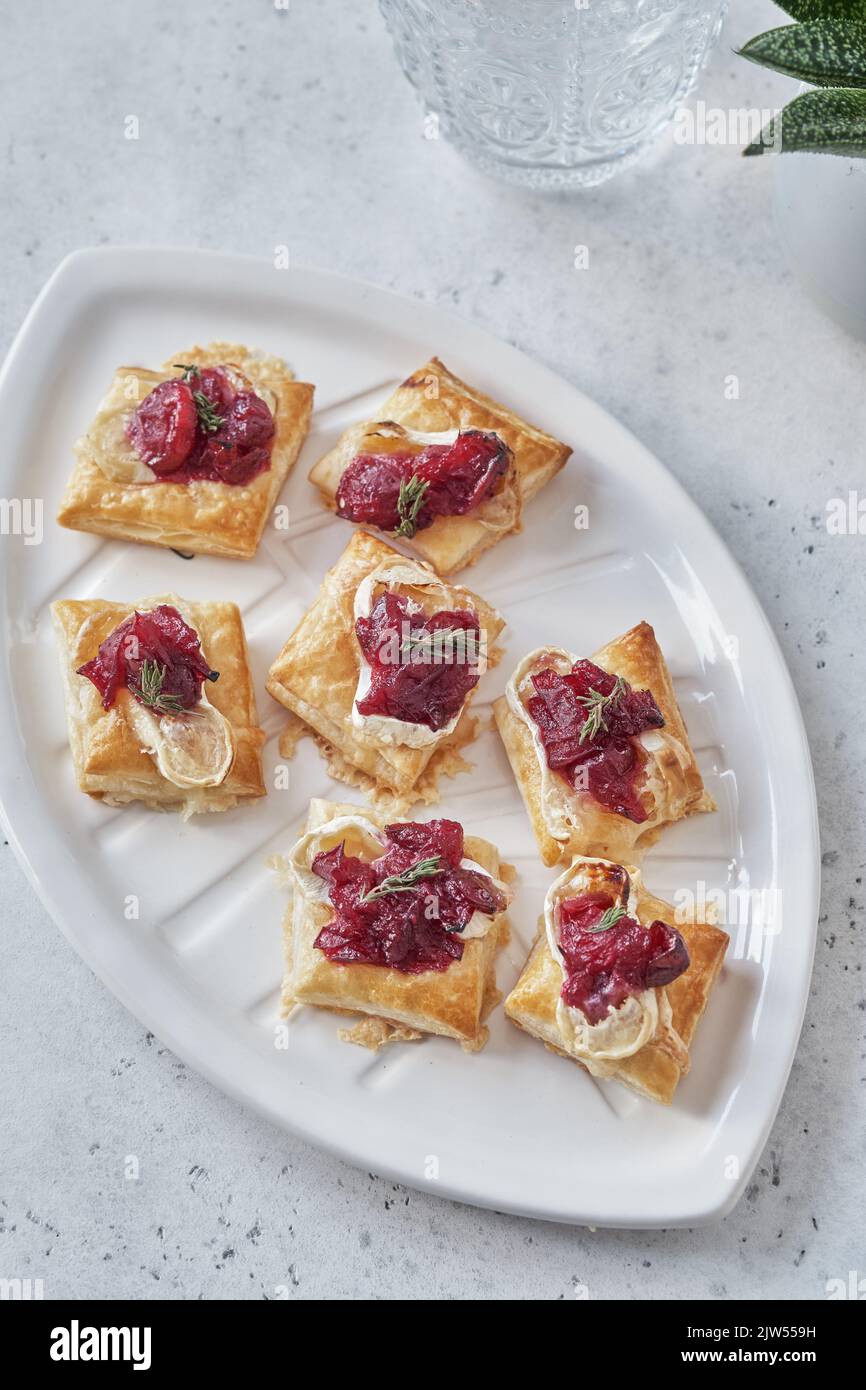 appetizers with cranberry sauce, brie cheese and thyme Stock Photo Alamy