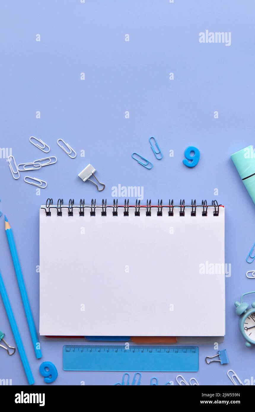School stationery and notebook on pastel lavender background, vertical flatlay. Stock Photo