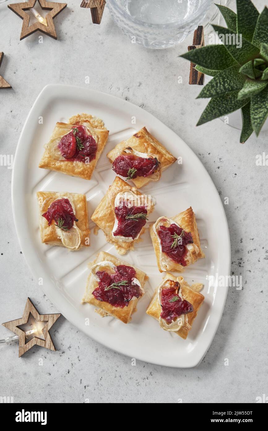 appetizers with cranberry sauce, brie cheese and thyme Stock Photo - Alamy