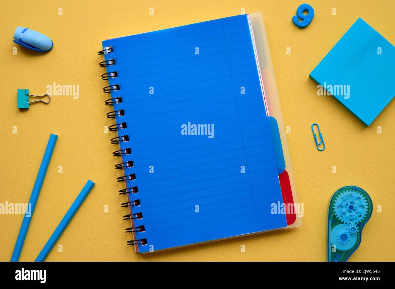 School stationery products on yellow background, flatlay. Back to school Stock Photo