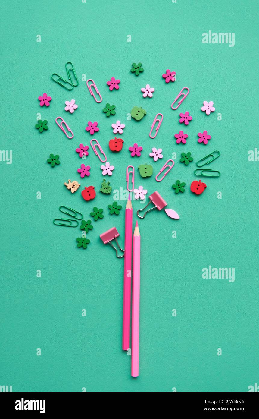 Conceptual tree made of pink pencils and school supplies, flat lay. Stock Photo