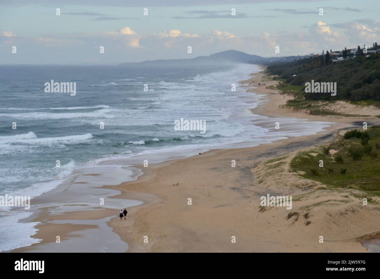 Wild  unruly surf beach with strong waves and rips on a stormy day looking from Noosa Heads National Park south along Sunshine Beach towards Mt Coolum Stock Photo