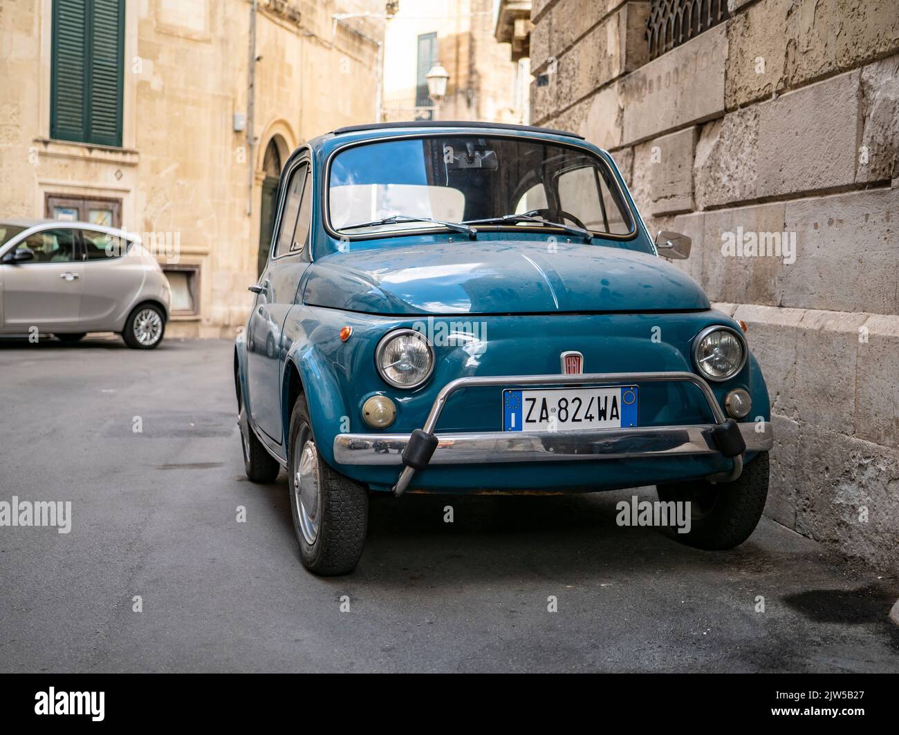 LECCE, ITALY - OCTOBER 27, 2021: Fiat 500 vintage car in narrow streets of Lecce in Italy Stock Photo