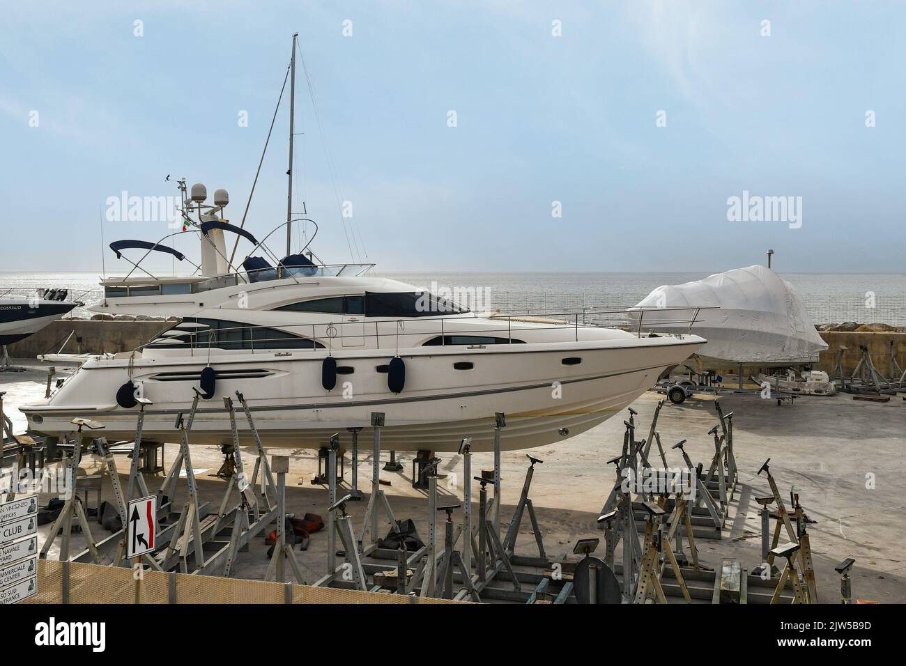 Dry boats in the shipyard of the Marina of San Vincenzo with the sea in the background, Livorno, Tuscany, Italy Stock Photo