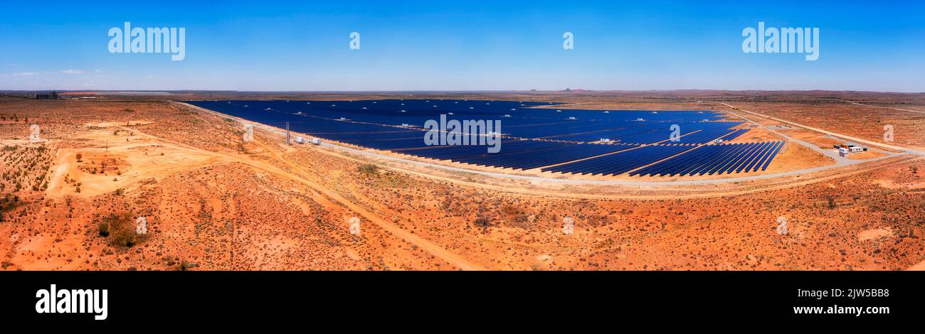 Broken hill solar plant in red soil Australian outback - wide aerial panorama. Stock Photo