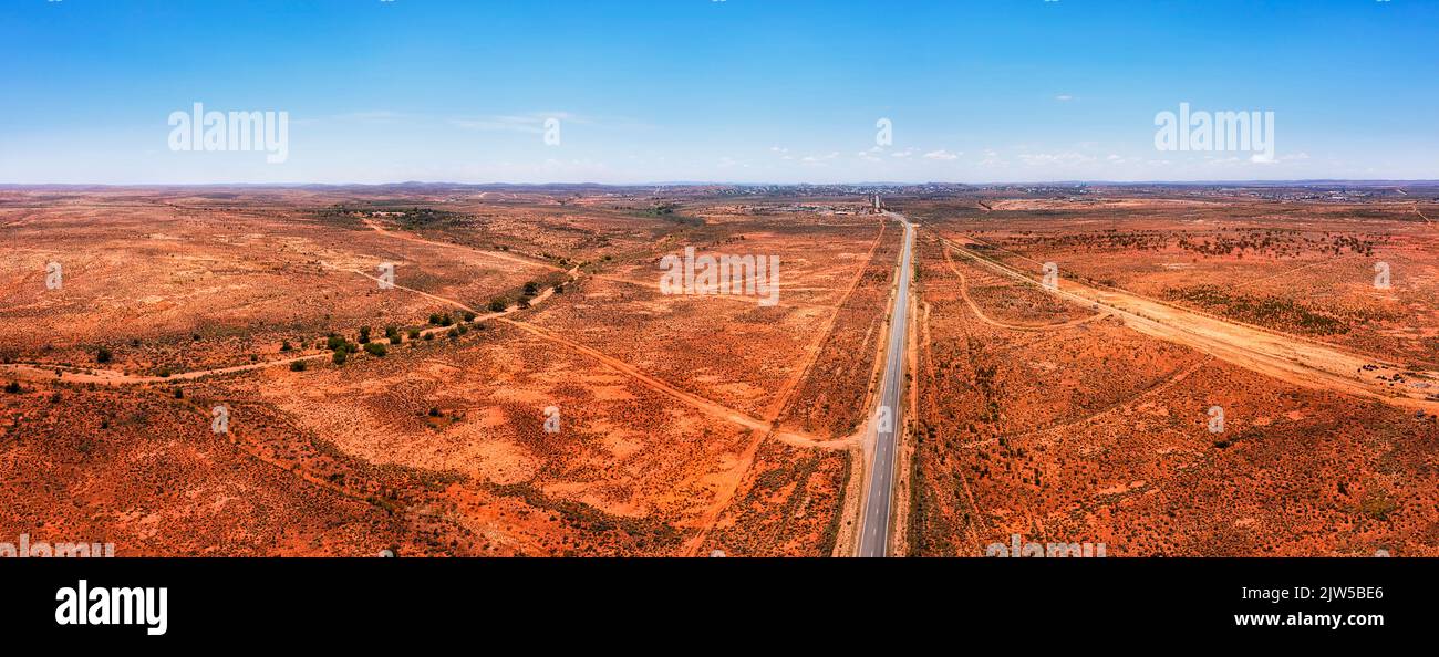 Silver City highway to Broken Hill city through red soil australian outback in wide aerial panorama Stock Photo