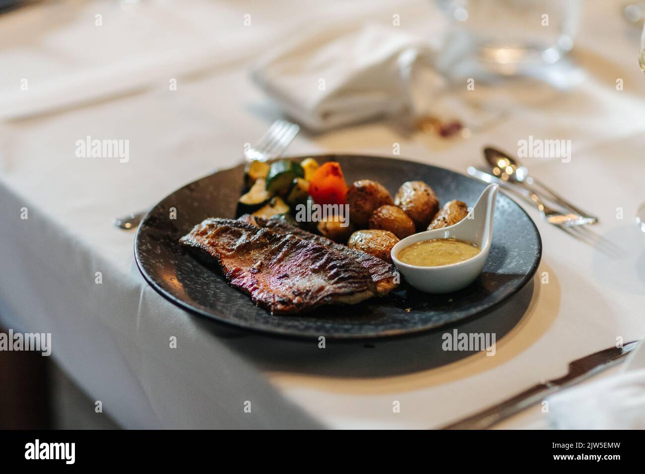 Delicious dinner beautifully arranged on a dinner plate. Stock Photo