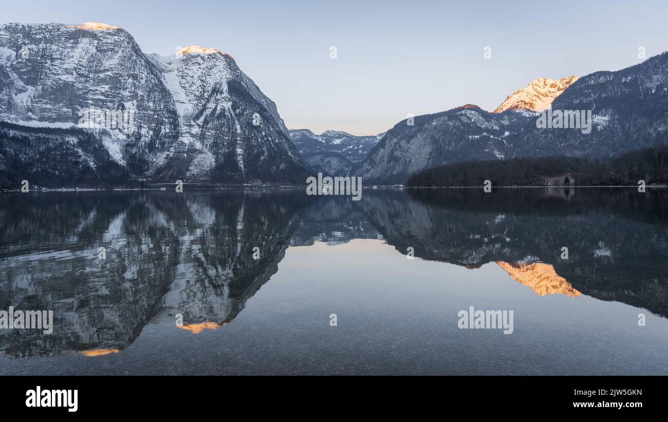 Beautiful alpine lake reflecting surrounding peaks during sunrise, panorama, Austria, Europe Stock Photo