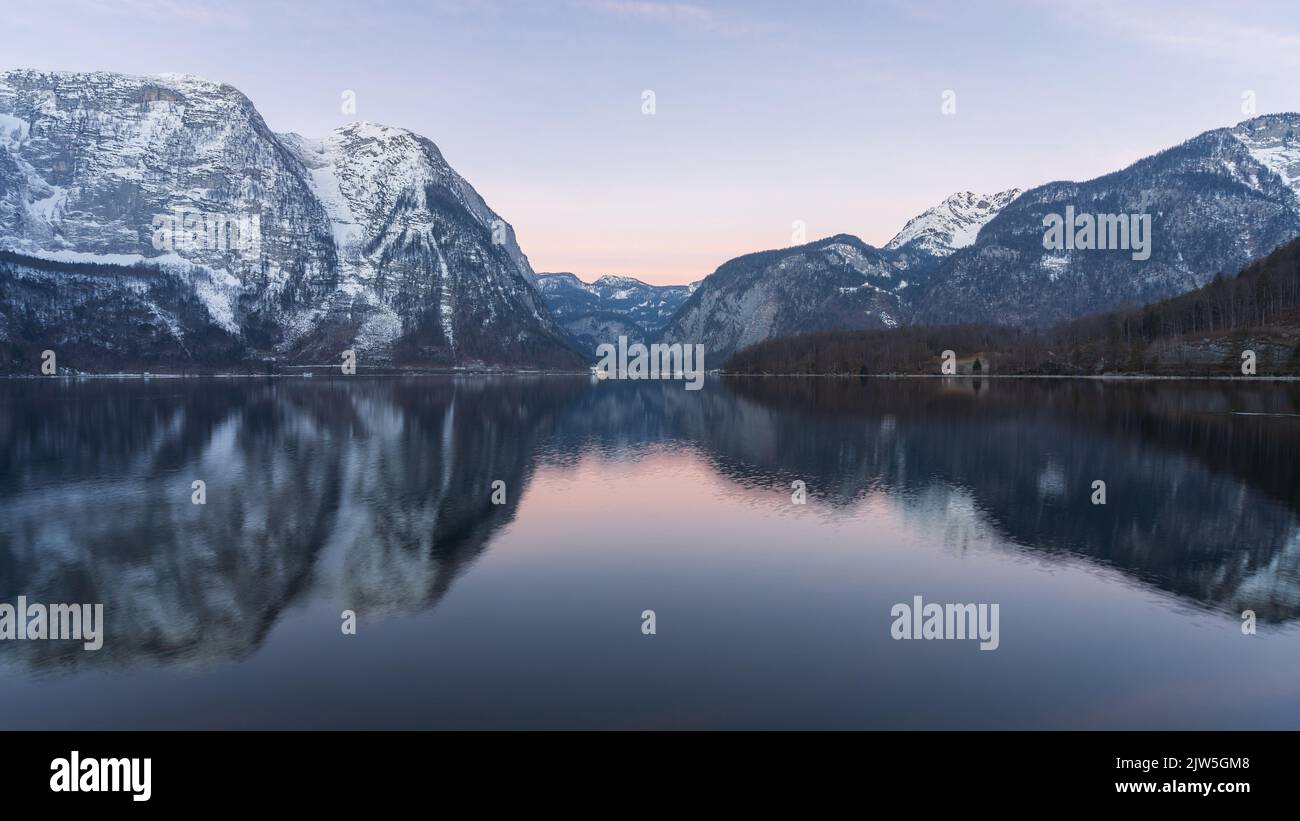 Beautiful alpine lake reflecting surrounding peaks during sunrise, wide shot, Austria, Europe Stock Photo