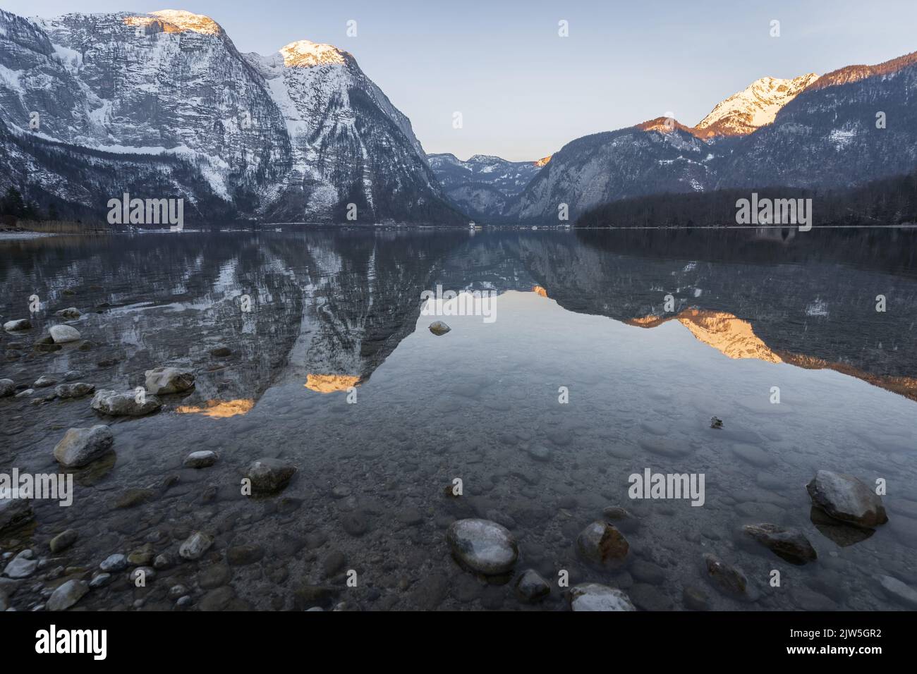 Beautiful alpine lake reflecting surrounding peaks during sunrise, Austria, Europe Stock Photo