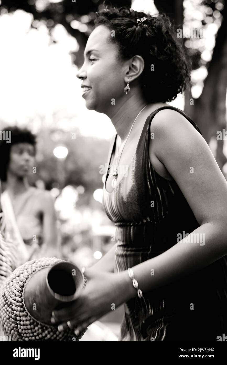 Salvador, Bahia, Brazil - September 17, 2016: Woman playing Abe or Xequere, percussion musical instrument created in Africa. Salvador, Bahia, Campo Gr Stock Photo