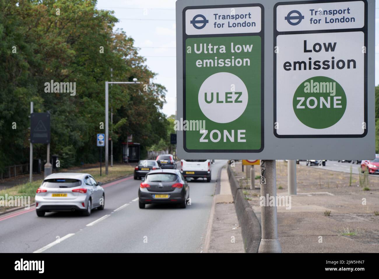 vehicles driving pass TFL signages for ULEZ Ultra Low Emission Zone