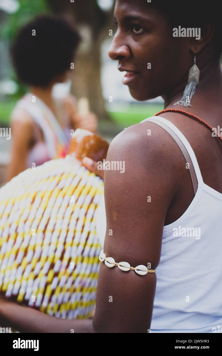 Salvador, Bahia, Brazil - September 17, 2016: Woman playing Abe or Xequere, percussion musical instrument created in Africa. Salvador, Bahia, Campo Gr Stock Photo