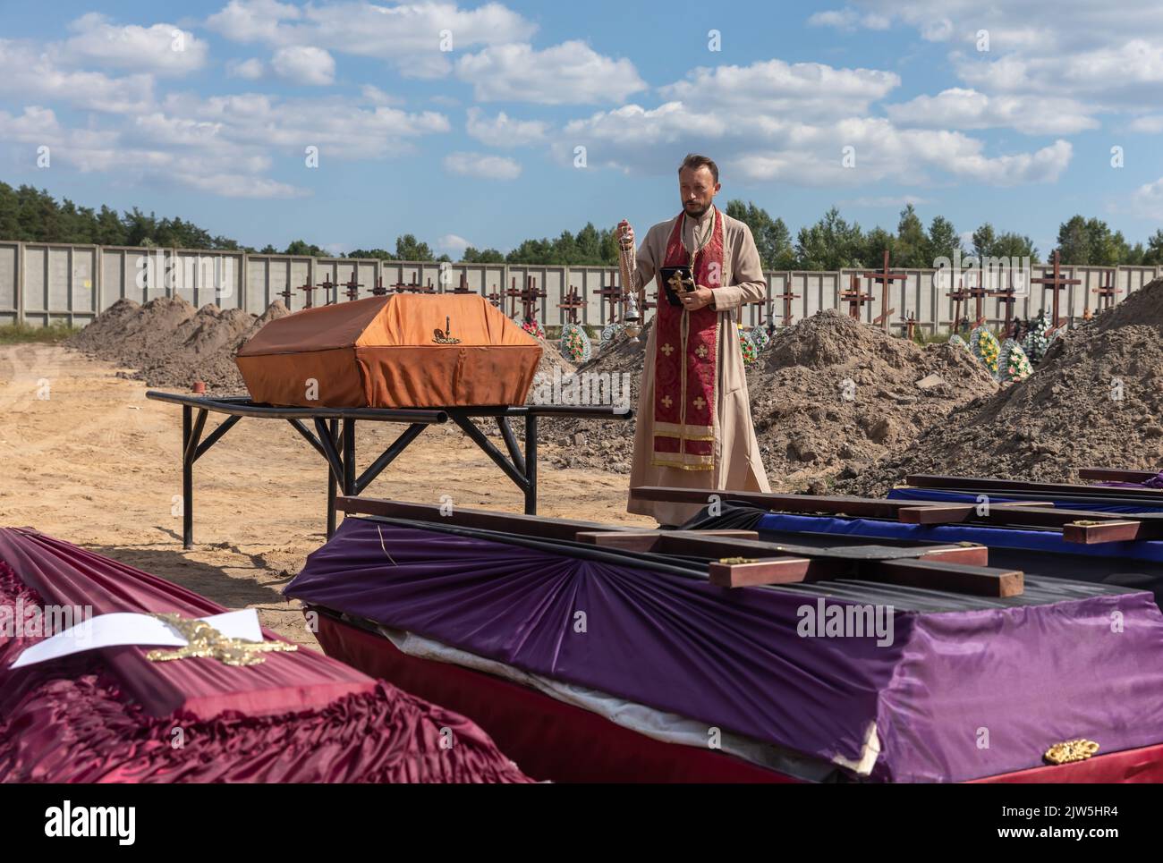 Bucha, Ukraine. 2nd Sep, 2022. A priest reads a prayer and performs a
