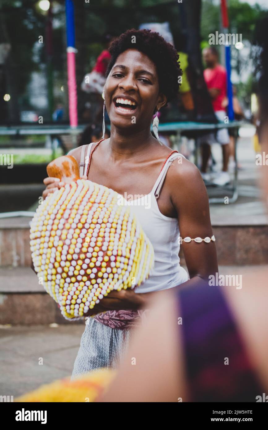 Salvador, Bahia, Brazil - September 17, 2016: Woman playing Abe or Xequere, percussion musical instrument created in Africa. Salvador, Bahia, Campo Gr Stock Photo