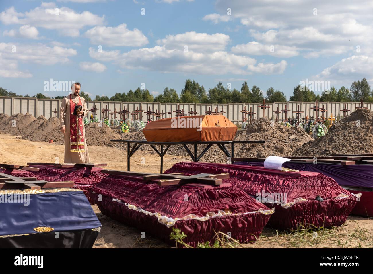 Bucha, Ukraine. 2nd Sep, 2022. A priest reads a prayer and performs a