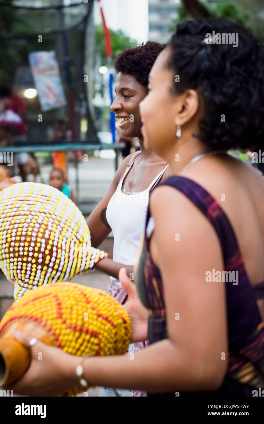 Salvador, Bahia, Brazil - September 17, 2016: Women playing Abe or Xequere, percussion musical instrument created in Africa. Salvador, Bahia, Campo Gr Stock Photo