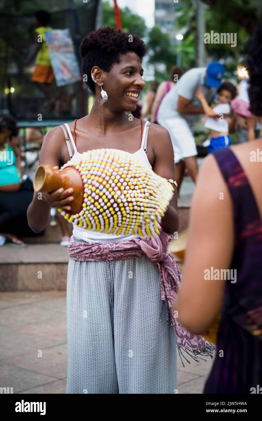 Salvador, Bahia, Brazil - September 17, 2016: Woman playing Abe or Xequere, percussion musical instrument created in Africa. Salvador, Bahia, Campo Gr Stock Photo