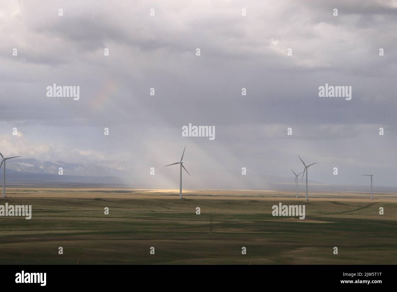 Solar Energy Windmill with Sunlight Shining Through Clouds in Montana Stock Photo