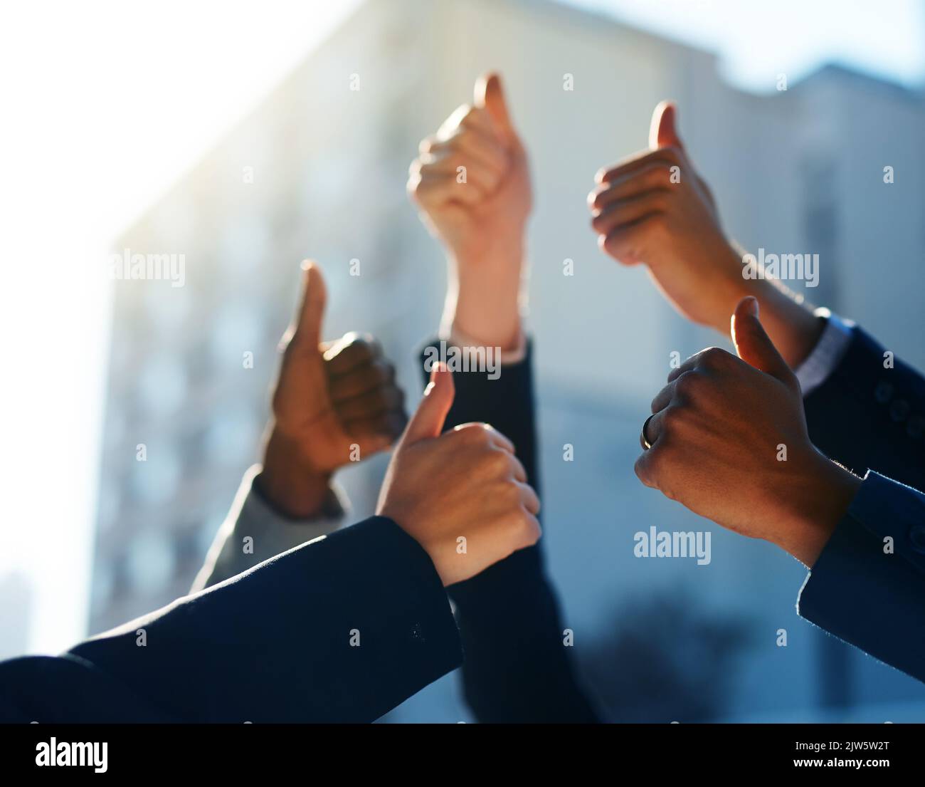 That was amazing. a group of office workers giving thumbs up together. Stock Photo